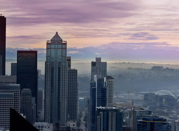 Sunrise in misty pink over Seattle with Mt. Rainier. Jerry and Lois Photography