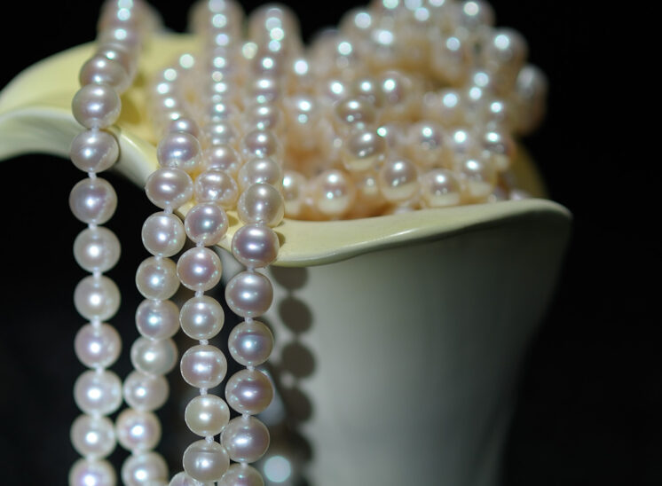 Glowing pearls draped and shaped with a porcelain calla lily. Jerry and Lois Photography