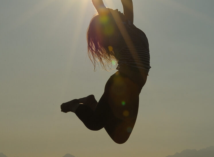 One-click: A gymnast flying up and catching the sun perfectly, graced by the Olympic Mountains and Puget sound for a stunning backdrop. Jerry and Lois Photography