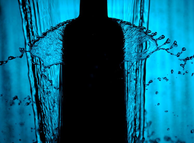 Water splashing down, frozen in crystal time for a product shot in a backlit silhouette. © Jerry and Lois Photography, all rights reserved