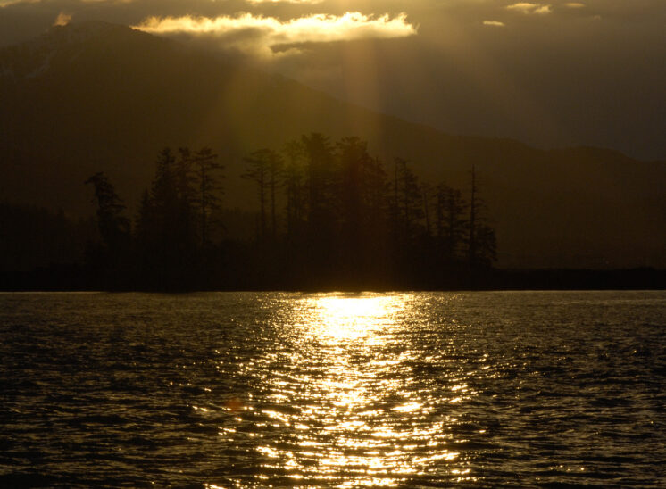 The golden light of an Inside Passage morning creates 3-dimensional layers with clouds, mountains, trees, and water ripples. Jerry and Lois Photography