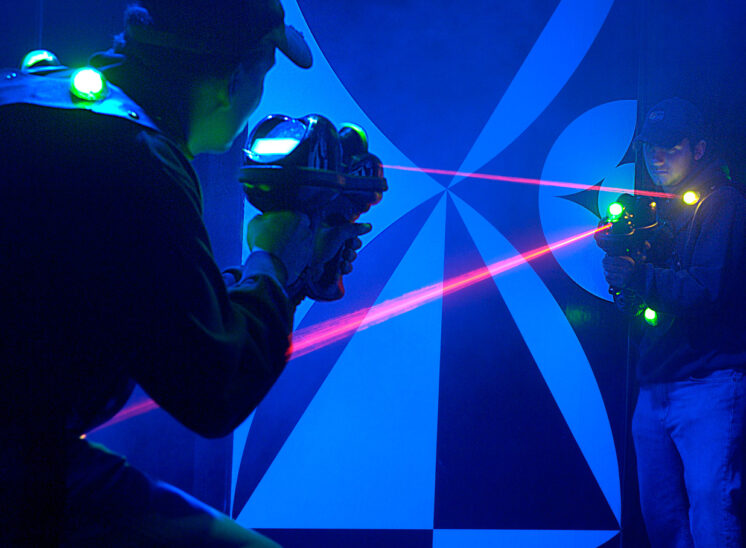 Family entertainment business owners demonstrating their new laser-tag maze. Jerry and Lois Photography